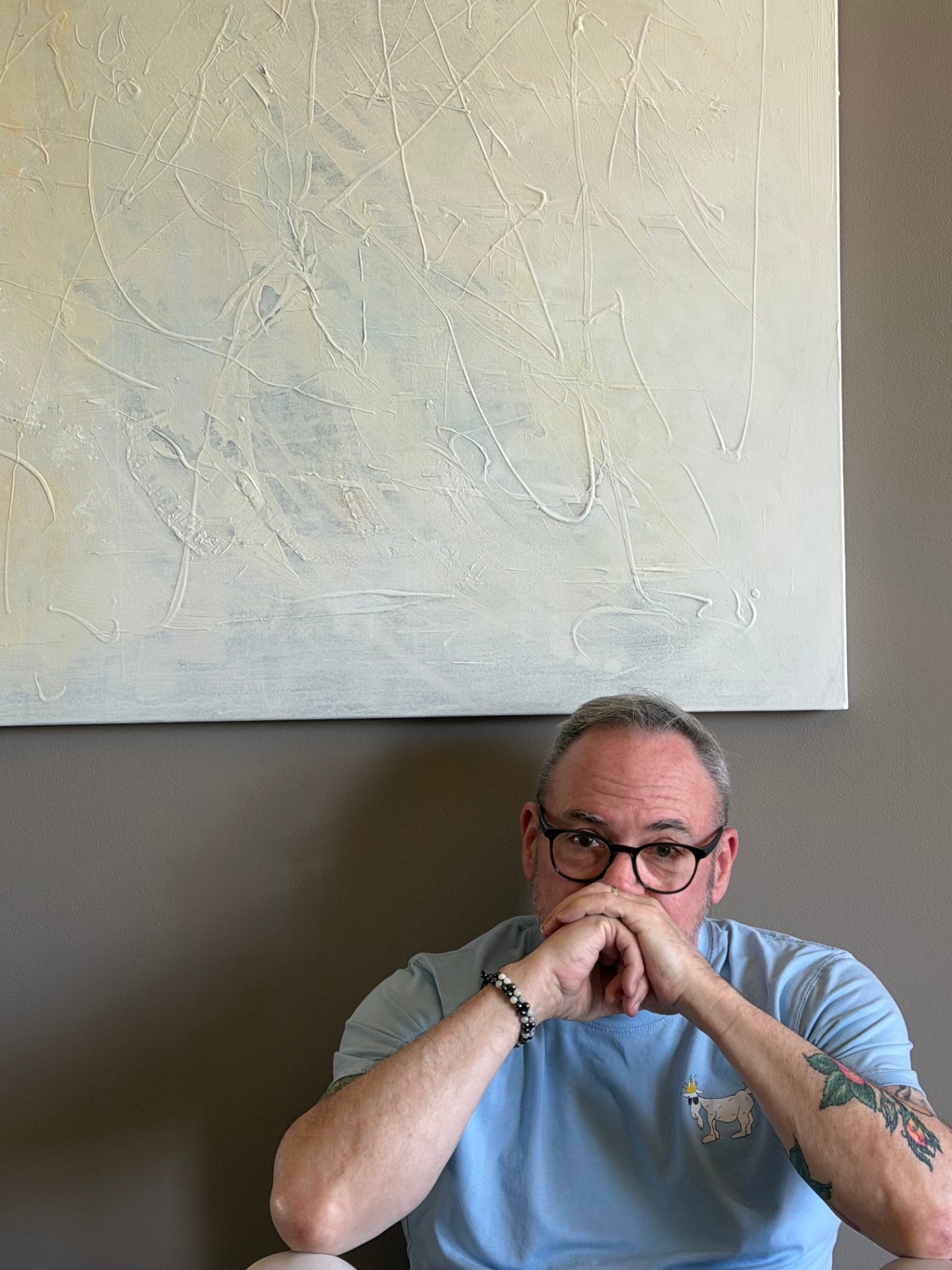 Tim, seated beneath his painting Weight