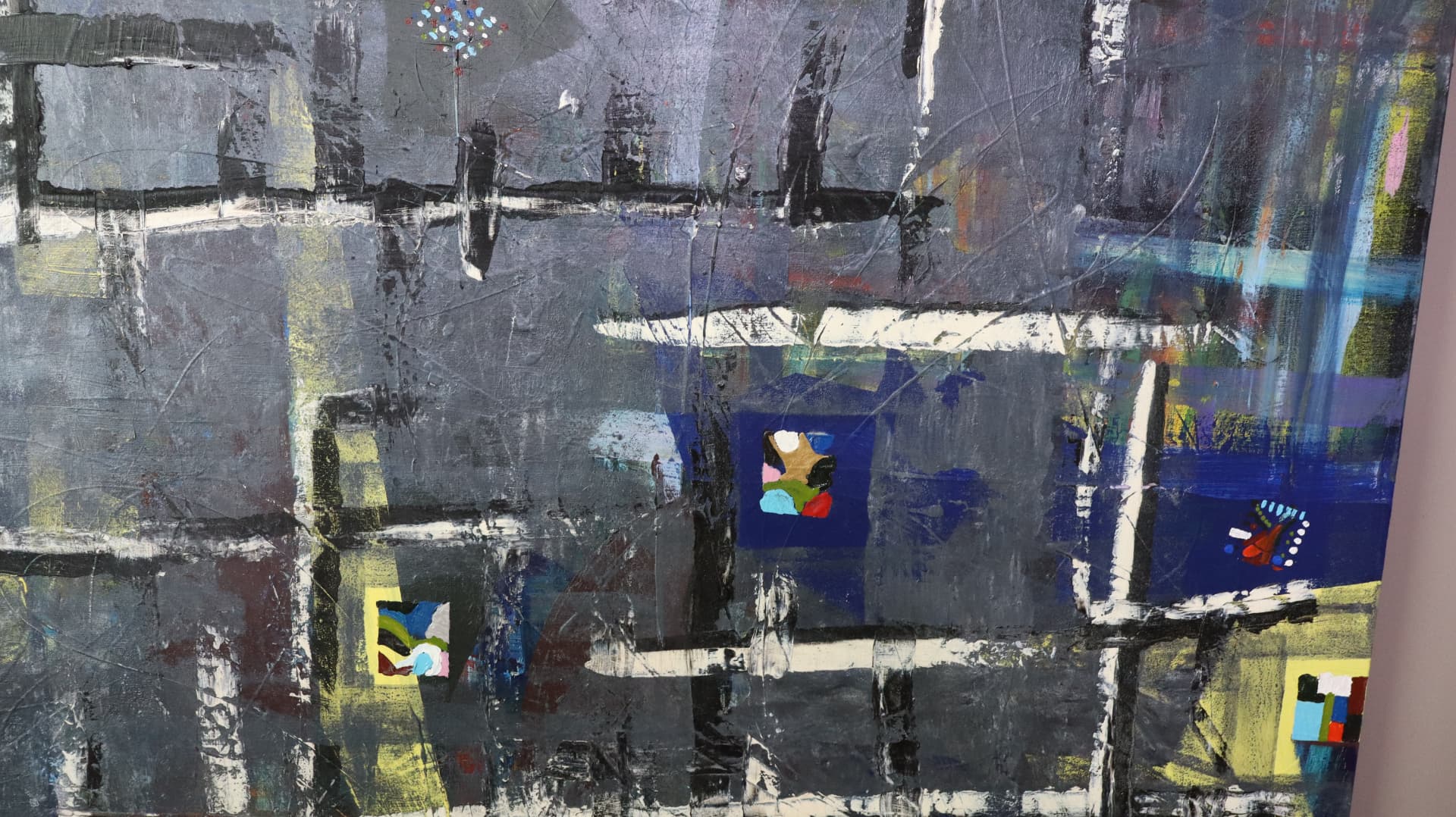 Laws — close-up detail of full surface grid with scattered color blocks and scraped texture