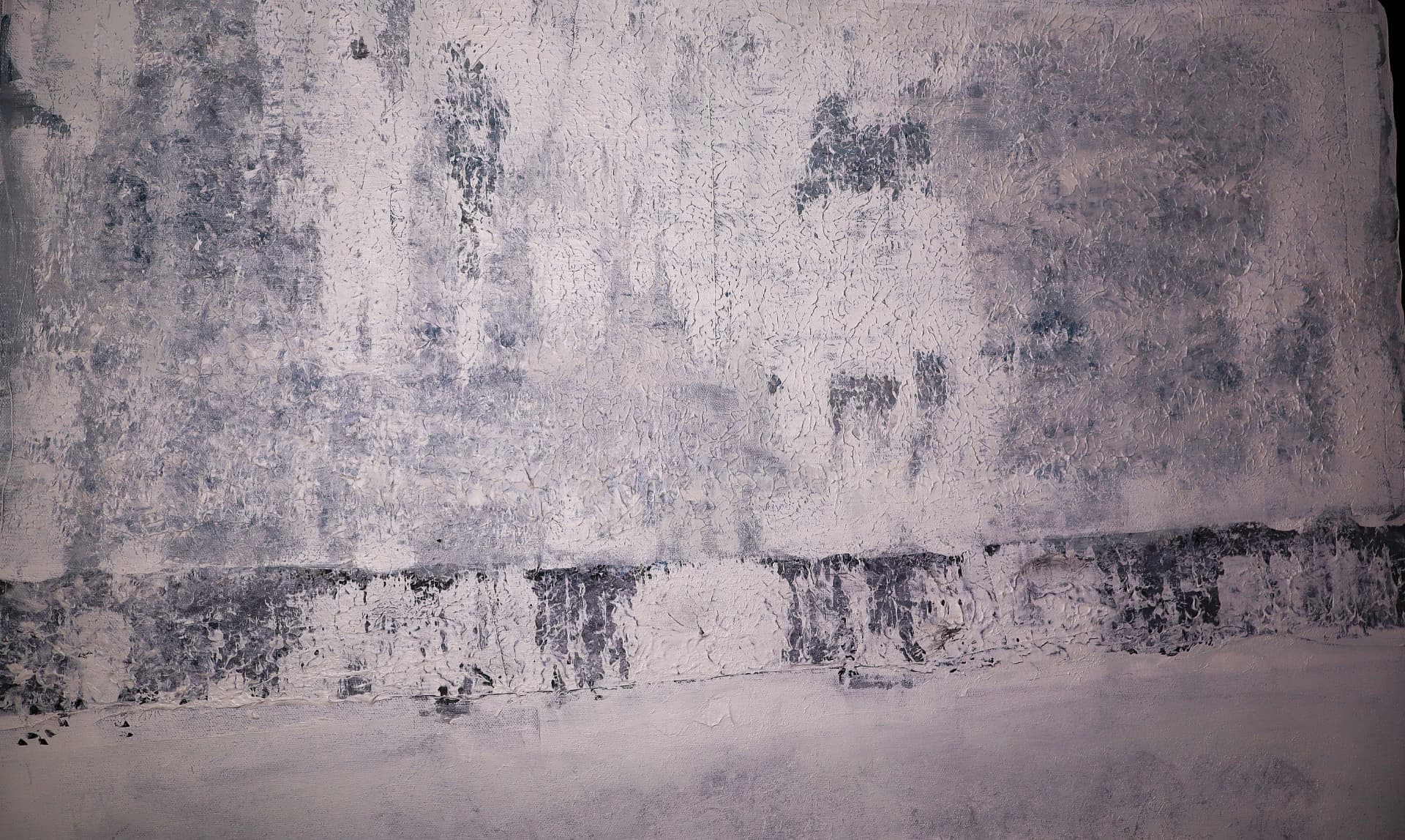 Winter — close-up detail of icy blue-gray texture and a dark, quiet horizon band