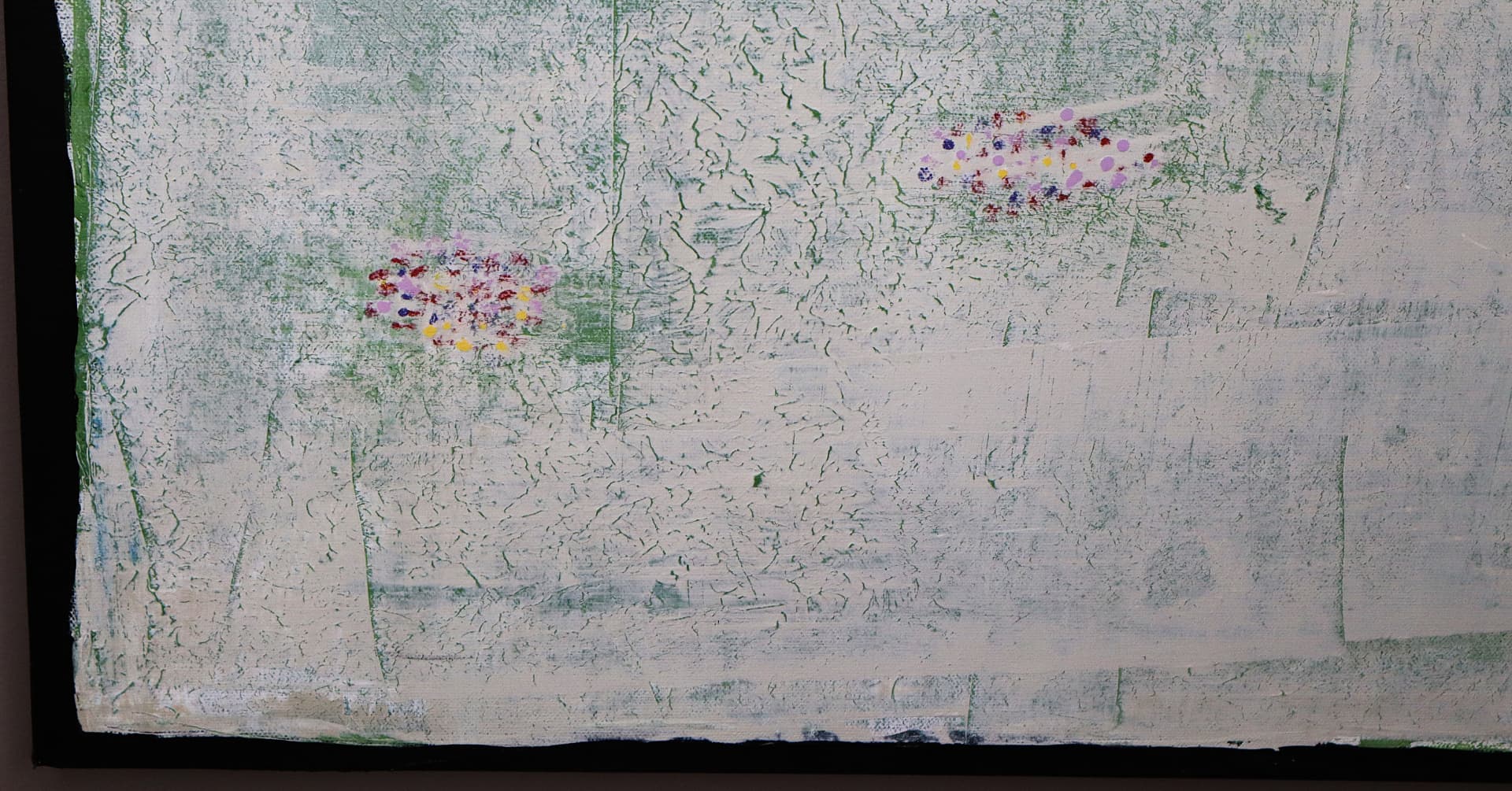 Spring — close-up detail of delicate green fissures and scattered bright flower-like marks